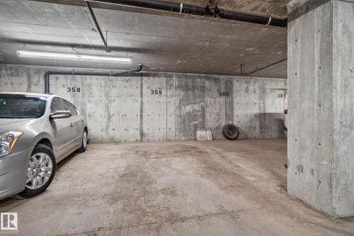 Concrete parking garage with exposed concrete walls, ceiling, and floor - 140 301 Clareview Station Drive, Edmonton, AB 