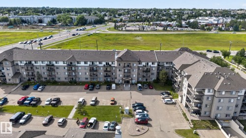 Multi-story residential building featuring a grey shingle roof and light grey siding - 140 301 Clareview Station Drive, Edmonton, AB 