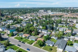 Aerial perspective showcasing a residential neighborhood with green spaces and varying architectural styles - 