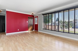 Living room / dining room with red walls and shutters - 