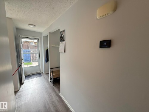 FRONT ENTRANCE HALLWAY TO THE LIVING ROOM, KITCHEN AND THE 2pc POWDER ROOM BEHIND THIS PHOTO! TAKE NOTE...THE PROGRAMABLE THERMOSTAT! - 166 Roseland Village, Edmonton, AB - Indoor Photo Showing Other Room
