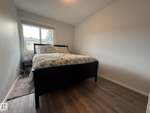 2nd Upstairs Bedroom with VINYL PLANK flooring, neutral wall tones, and a double window - 166 Roseland Village, Edmonton, AB - Indoor Photo Showing Bedroom