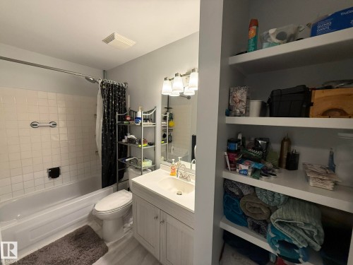 Upper Floor Full 4PC Bathroom featuring a white vanity with integrated sink, chrome faucet, and overhead vanity lighting - 166 Roseland Village, Edmonton, AB - Indoor Photo Showing Bathroom