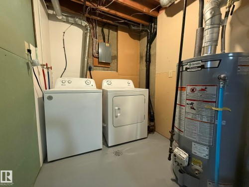 Dedicated utility area featuring a water heater, a washer, and a dryer - 166 Roseland Village, Edmonton, AB - Indoor Photo Showing Laundry Room