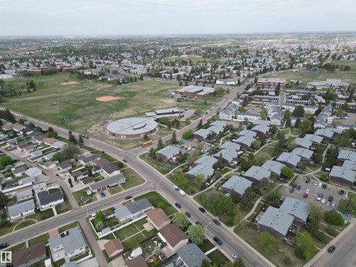 Aerial perspective showcasing a residential area with diverse housing styles, including single-family homes and multi-unit dwellings - 166 Roseland Village, Edmonton, AB -  With View