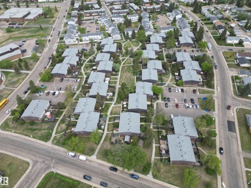 Aerial perspective showcasing a residential community layout with multiple buildings featuring gray shingle roofs - 166 Roseland Village, Edmonton, AB - Outdoor With View