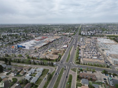 Aerial perspective showcasing a major commercial hub with extensive parking facilities, surrounded by residential areas and verdant tree-lined streets - 166 Roseland Village, Edmonton, AB - Outdoor With View