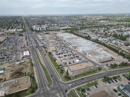 Expansive commercial retail development featuring multiple large-format buildings with extensive surface parking and direct access to a major thoroughfare - 166 Roseland Village, Edmonton, AB - Outdoor With View