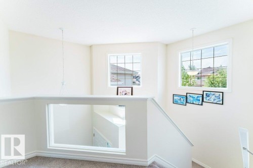 Upper-level landing featuring a carpeted floor, white painted walls, and white trim - 3525 22 Street, Edmonton, AB - Indoor Photo Showing Other Room