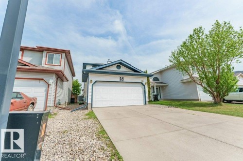 Front exterior showcasing a two-story residence with light-colored siding and dark trim - 3525 22 Street, Edmonton, AB - Outdoor