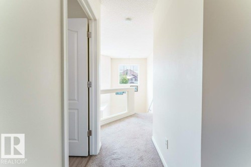 Upper-level hallway with neutral carpeting and light-toned wall finishes - 3525 22 Street, Edmonton, AB - Indoor Photo Showing Other Room