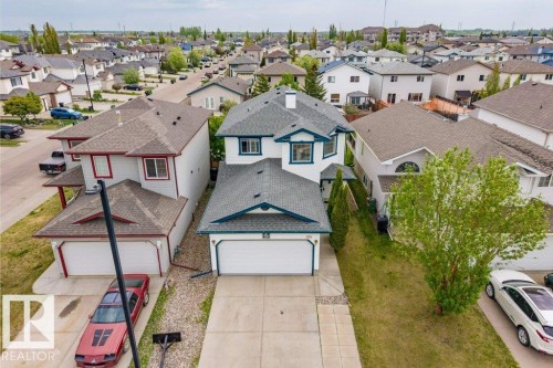 Two-story residence featuring a white and blue exterior, an attached two-car garage, and a concrete driveway - 3525 22 Street, Edmonton, AB - Outdoor