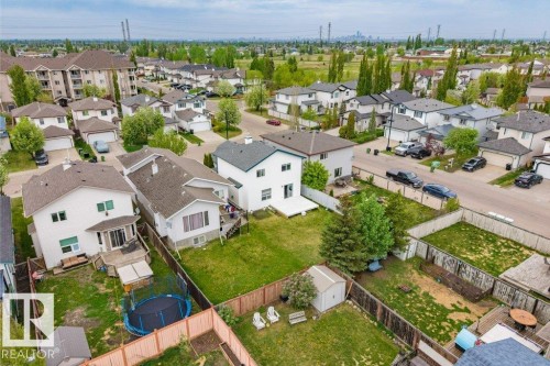 Expansive residential property featuring a large backyard, a white exterior, and a rear deck - 3525 22 Street, Edmonton, AB - Outdoor With View