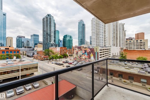 Balcony featuring a glass and metal railing, concrete flooring, and a comprehensive city skyline backdrop - 608 10303 105 Street, Edmonton, AB 