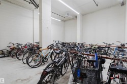 Dedicated bike storage area featuring multiple racks and overhead strip lighting - 