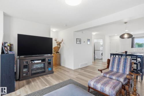 Open-concept living area featuring light wood-finish flooring throughout - 58 Jensen Gate, St. Albert, AB 