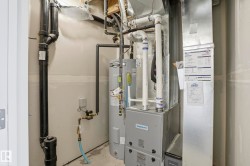 Utility area with water heater, furnace, and exposed plumbing - 