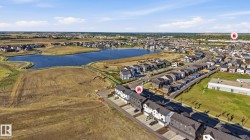 Aerial perspective showcasing a residential development with a prominent water feature - 