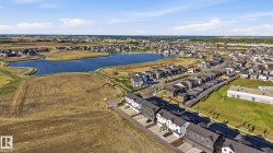Expansive aerial view showcasing a developed residential area with a prominent body of water - 