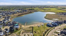 Lakefront community featuring a private beach and dock access - 