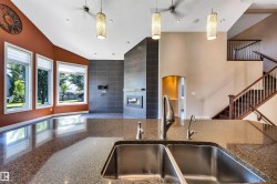 Kitchen island featuring a dual stainless steel sink and granite-finish countertop - 
