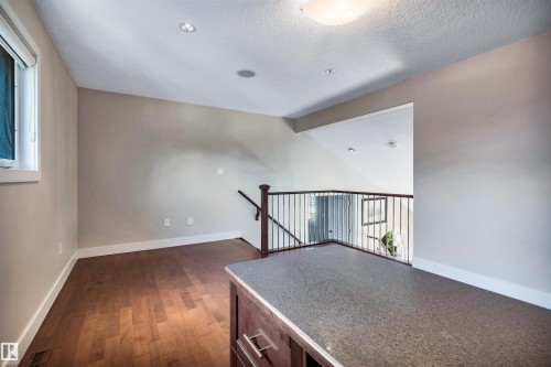 Loft area featuring wood-finish flooring, neutral wall tones, a built-in speaker, and recessed lighting - 9 Shorewood Crescent, Leduc, AB - Indoor Photo Showing Other Room