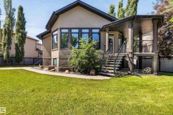 Stucco exterior with dark trim and multiple windows - 