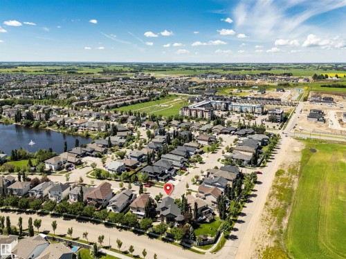 Aerial overview of a residential neighborhood with surrounding green spaces - 9 Shorewood Crescent, Leduc, AB - Outdoor With View