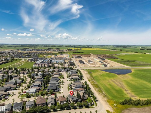 Aerial perspective showcasing an established neighborhood with verdant landscaping, surrounded by open fields and agricultural land - 9 Shorewood Crescent, Leduc, AB - Outdoor With View