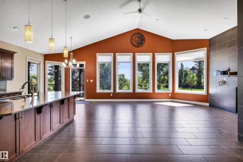 Spacious living area featuring vaulted ceilings, large rectangular windows, and dark tile flooring - 9 Shorewood Crescent, Leduc, AB - Indoor Photo Showing Kitchen With Double Sink