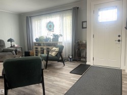 Entry foyer with a paneled door featuring a decorative glass insert - 