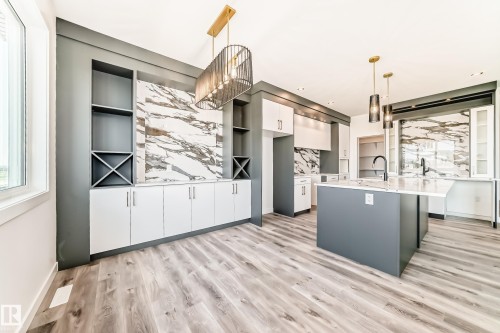 Open-concept kitchen and dining area featuring a large center island with a white countertop - 14 Tenuto Link, Spruce Grove, AB - Indoor Photo Showing Kitchen