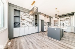 Open-concept kitchen and dining area featuring a large center island with a white countertop - 