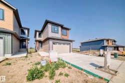 Contemporary two-story residence featuring a multi-textured exterior, an attached garage, and a concrete driveway - 