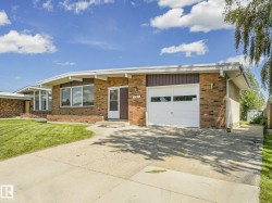 Brick exterior residence featuring a single-car garage and a concrete driveway - 