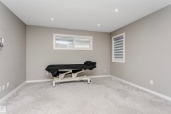 Carpeted room featuring light gray walls, recessed lighting, and white baseboards - 