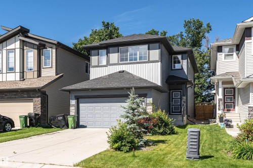 Contemporary two-story residence featuring a gray exterior with vertical and horizontal siding accents - 7322 Chivers Crescent, Edmonton, AB 