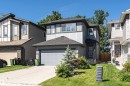 Contemporary two-story residence featuring a gray exterior with vertical and horizontal siding accents - 7322 Chivers Crescent, Edmonton, AB 