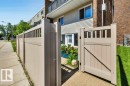 Tan fencing with a matching gate providing access to a private patio area - 102 7805 159 Street, Edmonton, AB 