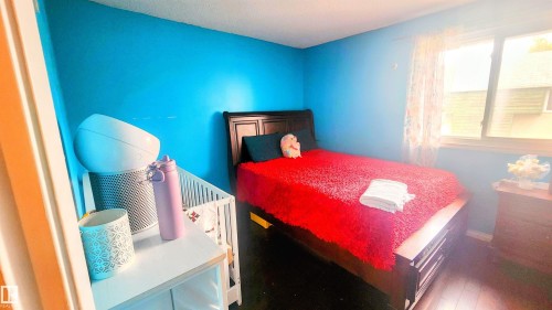 Bedroom featuring wood finished floors and baseboards - 704 Abbottsfield Road, Edmonton, AB - Indoor Photo Showing Bedroom