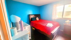 Bedroom featuring wood finished floors and baseboards - 