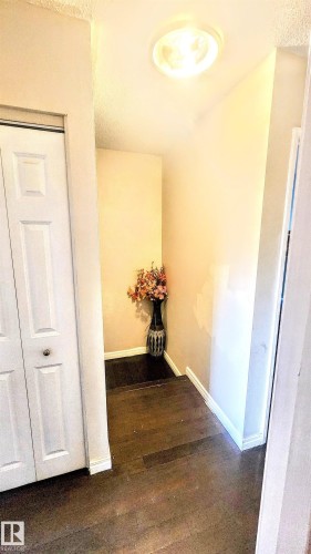 Hallway featuring dark wood-style flooring and a textured ceiling - 704 Abbottsfield Road, Edmonton, AB - Indoor Photo Showing Other Room