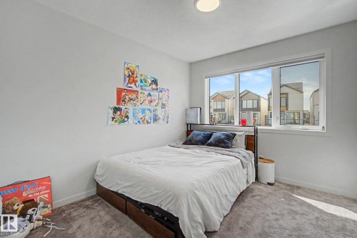 Bright room featuring a large window, neutral wall paint, and gray carpet flooring - 3313 Kulay Way, Edmonton, AB 