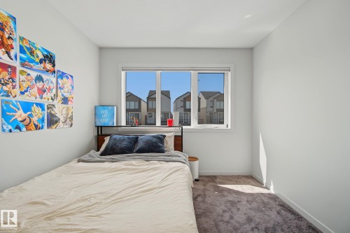 Bedroom featuring light gray walls, a window with white trim, and a carpeted floor - 3313 Kulay Way, Edmonton, AB 