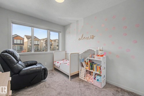 Bright room featuring a large window, light gray carpet, and white walls - 3313 Kulay Way, Edmonton, AB 