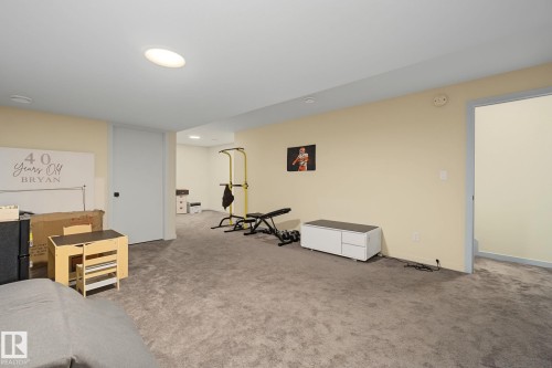 Spacious carpeted room featuring recessed lighting, light-toned walls, and multiple access points - 3313 Kulay Way, Edmonton, AB 