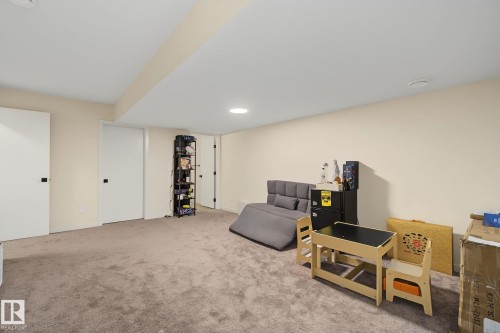 Expansive room featuring neutral-toned carpet flooring, light cream wall paint, and recessed ceiling lighting - 3313 Kulay Way, Edmonton, AB 