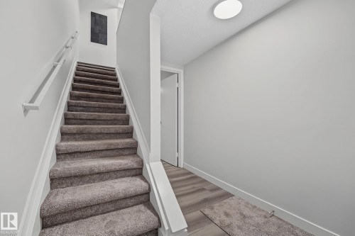 Stairs to main level. - 661 Abbottsfield Road Nw, Edmonton, AB - Indoor Photo Showing Other Room