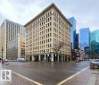 Historic 8-story commercial building featuring classic architectural detailing, ground-level retail spaces, and multiple upper-floor window arrangements - 210 10134 100 Street, Edmonton, AB 