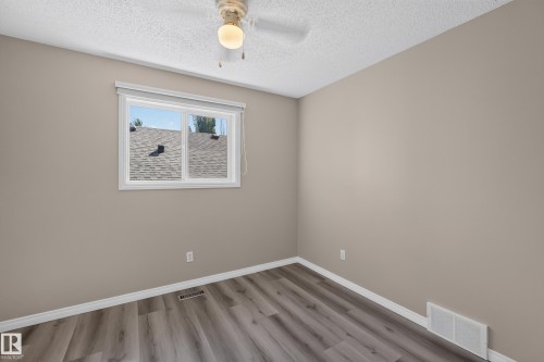 Neutral tone walls with white trim and wood-finish flooring - 2327 37B Avenue, Edmonton, AB 